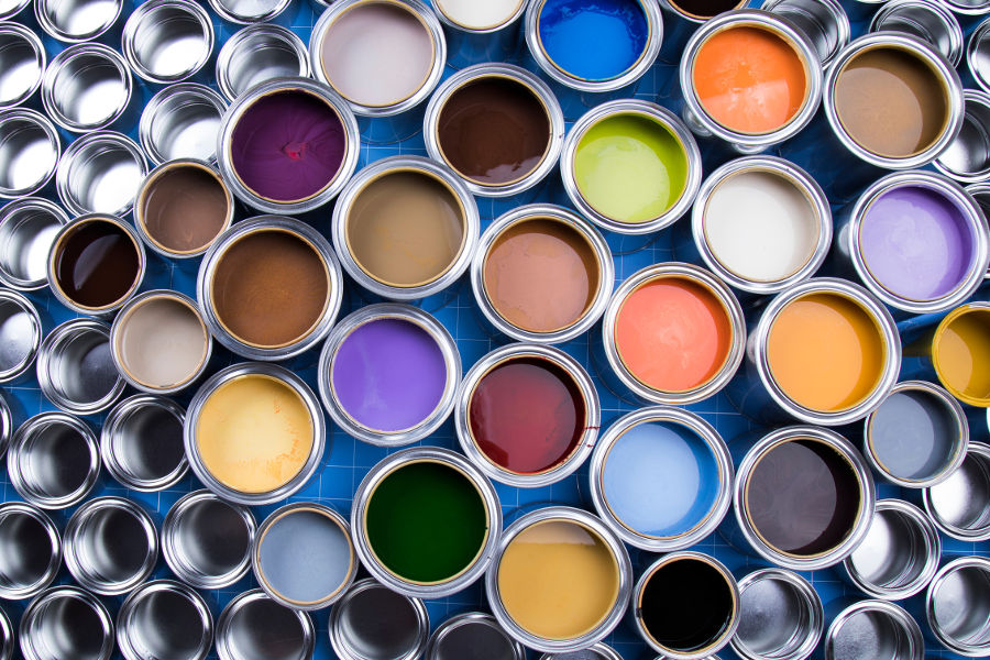 Multiple colorful cans of paint